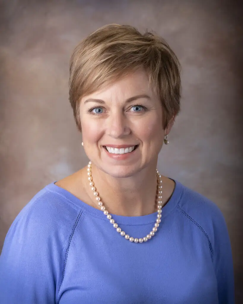 Jennifer Moore, Clinical Director at MCVA, smiling wearing a pearl necklace and lavender shirt